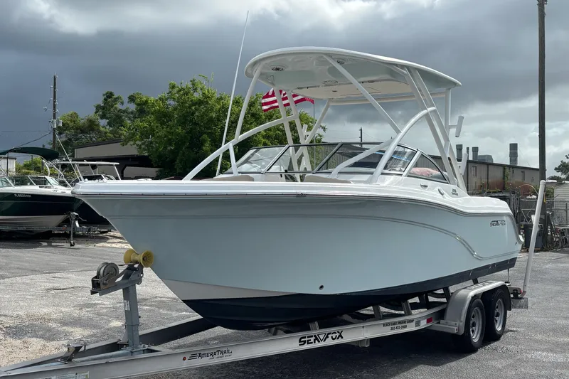 Slide: The Image of 2019 Sea Fox 226 Traveler boat on trailer, parked outdoors under cloudy sky. - 10
