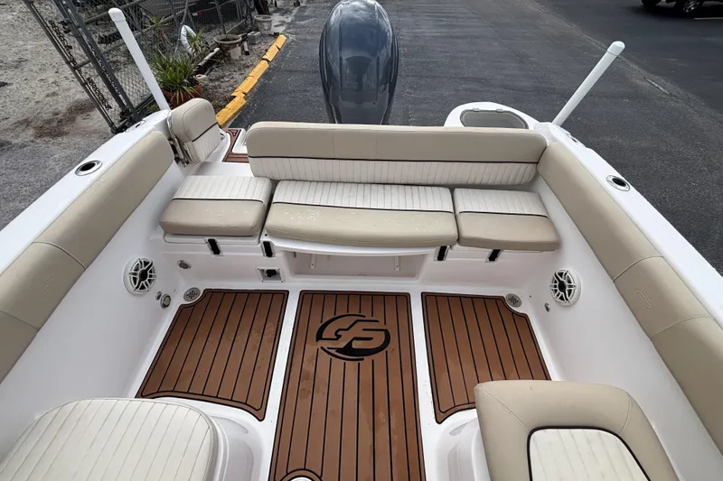 Slide: The Image of 2019 Sea Fox 226 Traveler boat interior with cushioned seating and teak-style flooring. - 22