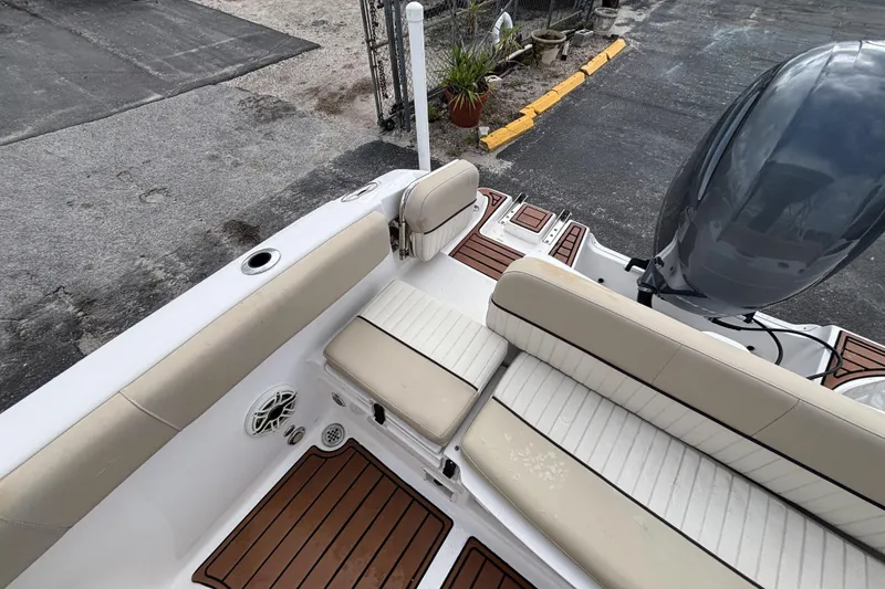 Slide: The Image of 2019 Sea Fox 226 Traveler boat interior with cushioned seating and outboard motor. - 23