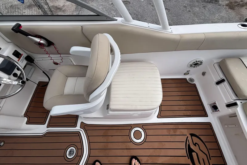 Slide: The Image of 2019 Sea Fox 226 Traveler boat interior with beige seating and wood-patterned flooring. - 29