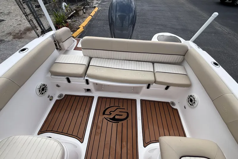 Slide: The Image of 2019 Sea Fox 226 Traveler boat interior with cushioned seating and teak-style flooring. - 30