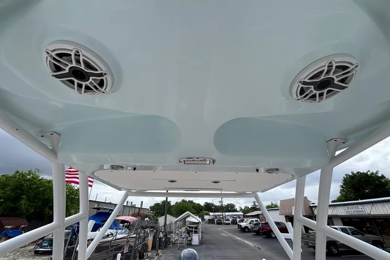 Slide: The Image of 2019 Sea Fox 226 Traveler boat speakers and canopy, docked at a marina. - 35