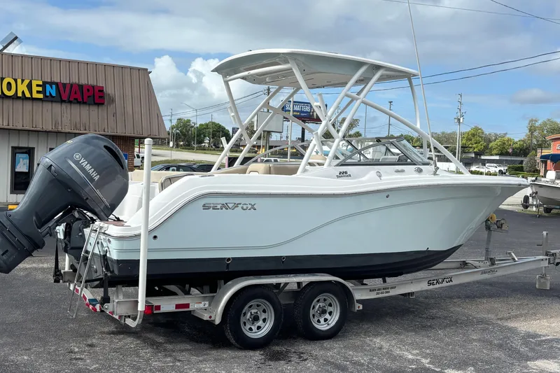 Slide: The Image of 2019 Sea Fox 226 Traveler boat on trailer, parked near a store. - 5