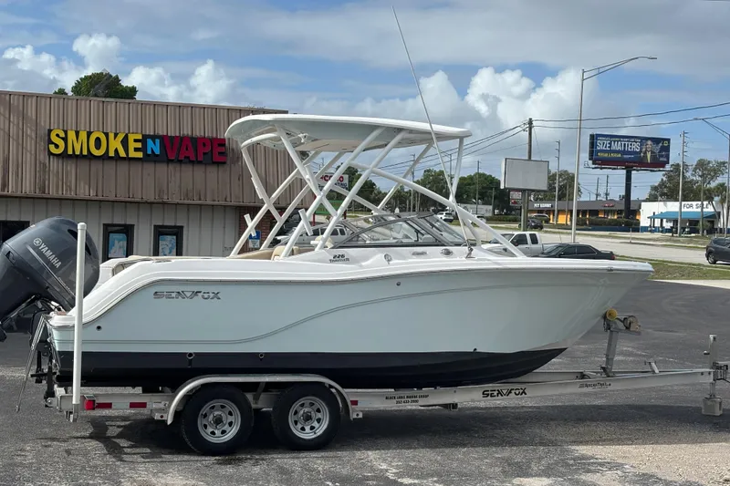 Slide: The Image of 2019 Sea Fox 226 Traveler boat on trailer near a store, with Yamaha engine. - 7