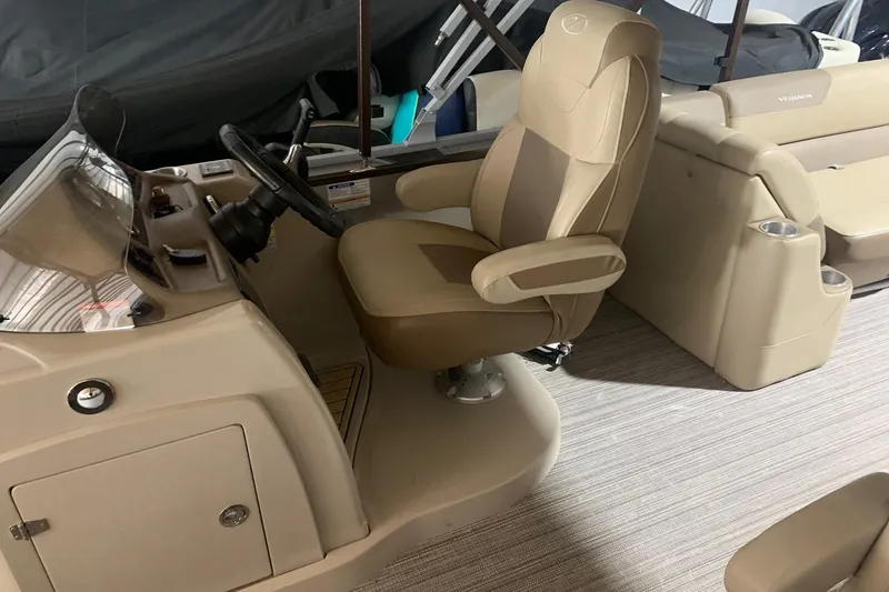 Slide: The Image of Captain's chair and console of 2019 Veranda Relax VR25RC boat, featuring beige upholstery. - 10