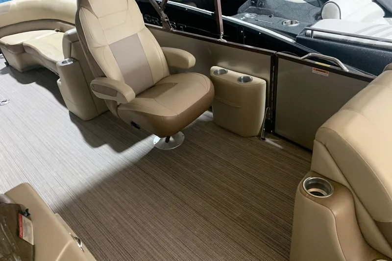 Slide: The Image of 2019 Veranda Relax VR25RC boat interior with beige seating and cup holders. - 11
