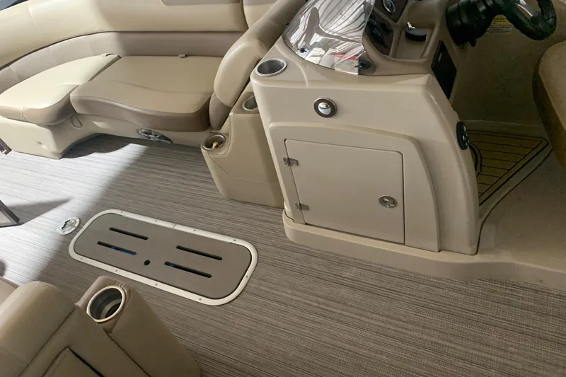 Slide: The Image of 2019 Veranda Relax VR25RC boat interior with beige seating and console. - 12