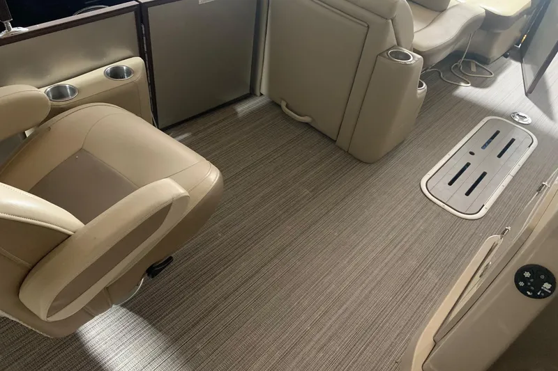 Slide: The Image of Interior of a 2019 Veranda Relax VR25RC boat with beige seating and flooring. - 13