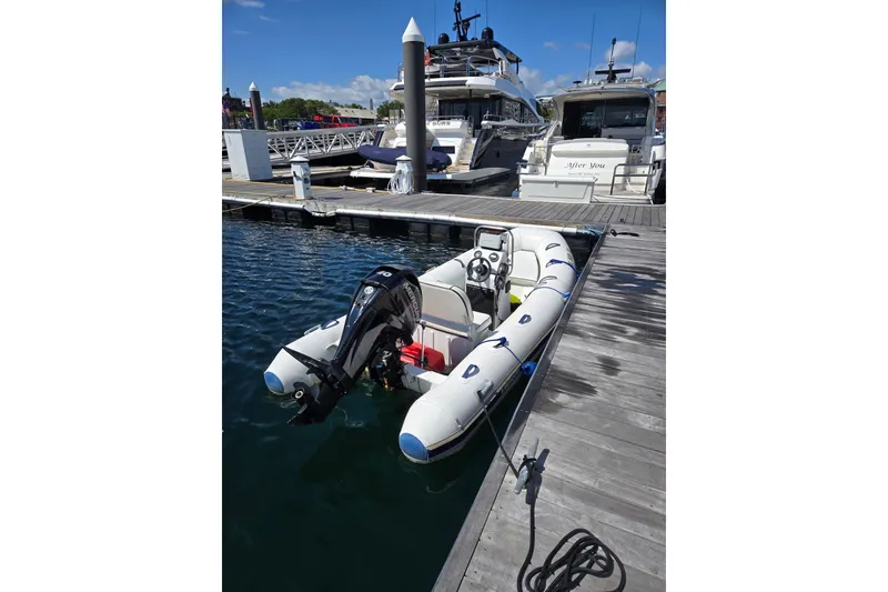 Slide: The Image of 2016 Quicksilver Center Console boat docked at marina with yachts in background. - 4