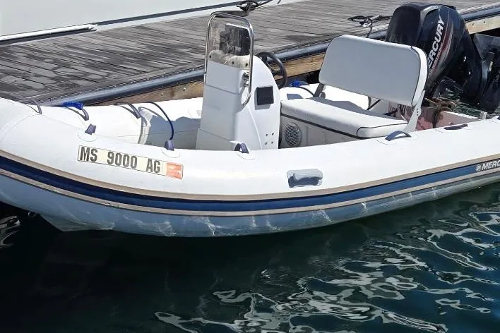 Slide: The Image of 2016 Quicksilver Center Console boat docked, featuring a Mercury outboard motor. - 7