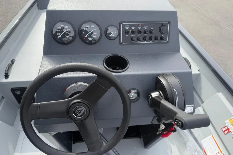 Slide: The Image of 2026 Crestliner 1760 Retriever FCC boat dashboard with steering wheel and control panel. - 5