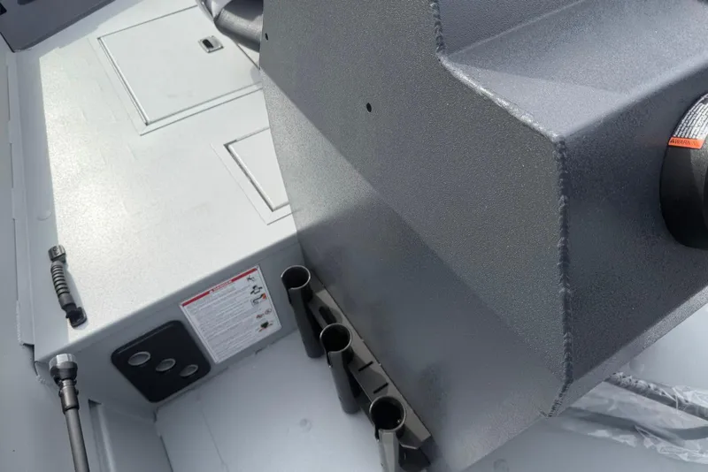 Slide: The Image of 2026 Crestliner 1760 Retriever FCC boat interior with storage compartments and rod holders. - 6