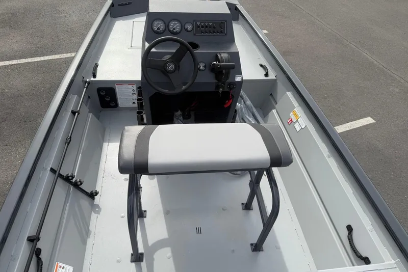 Slide: The Image of 2026 Crestliner 1760 Retriever FCC boat interior with steering console and seating. - 7