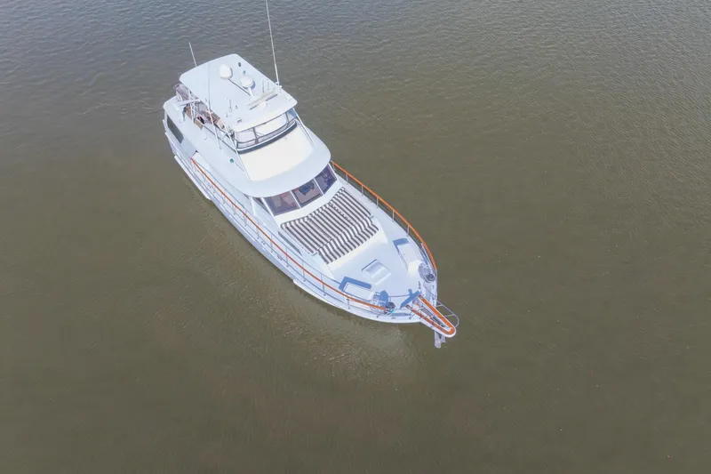Slide: The Image of 1980 Hatteras 53 Motor Yacht on calm water, aerial view. - 10