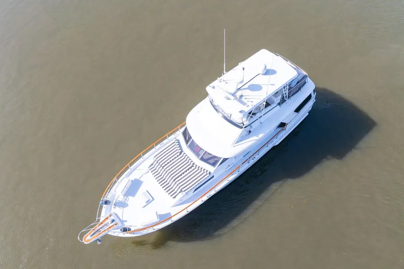 Slide: The Image of 1980 Hatteras 53 Motor Yacht cruising on calm waters, aerial view. - 12