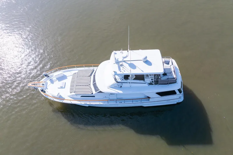 Slide: The Image of 1980 Hatteras 53 Motor Yacht on calm water, aerial view. - 13