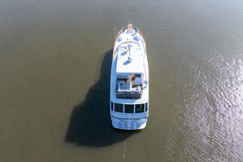 Slide: The Image of Aerial view of 1980 Hatteras 53 Motor Yacht on calm water. - 15