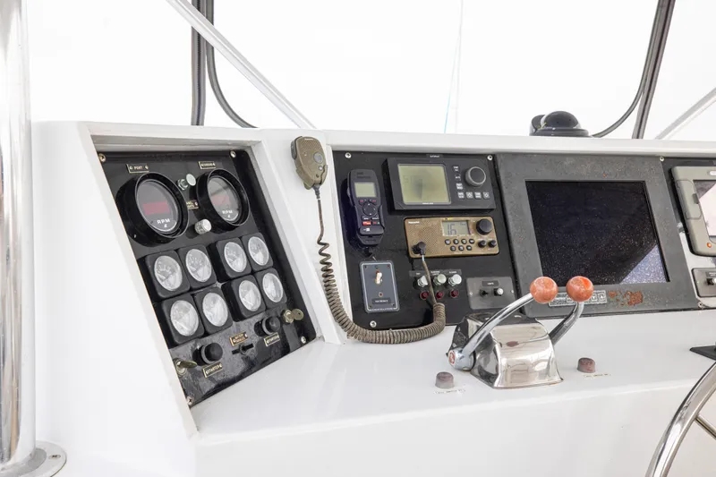 Slide: The Image of Control panel of a 1980 Hatteras 53 Motor Yacht with gauges and navigation equipment. - 20