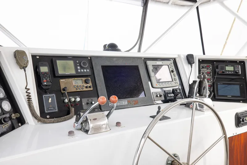 Slide: The Image of 1980 Hatteras 53 Motor Yacht helm with navigation equipment and steering wheel. - 21
