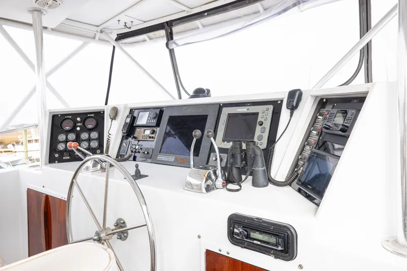 Slide: The Image of Helm of 1980 Hatteras 53 Motor Yacht with navigation instruments and steering wheel. - 23