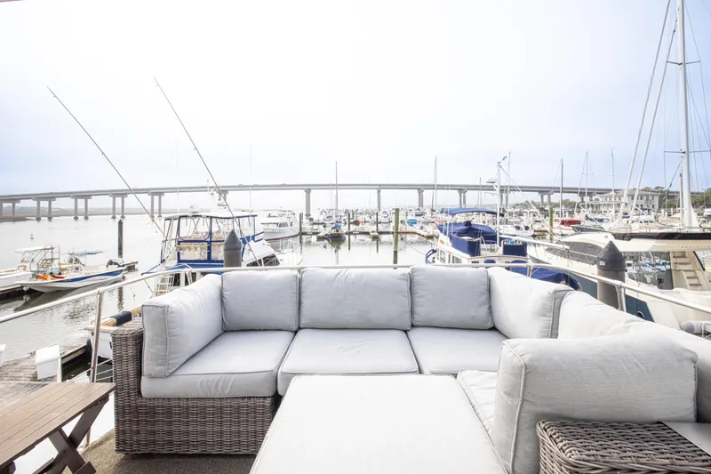 Slide: The Image of Luxurious 1980 Hatteras 53 Motor Yacht with marina view and comfortable outdoor seating. - 28