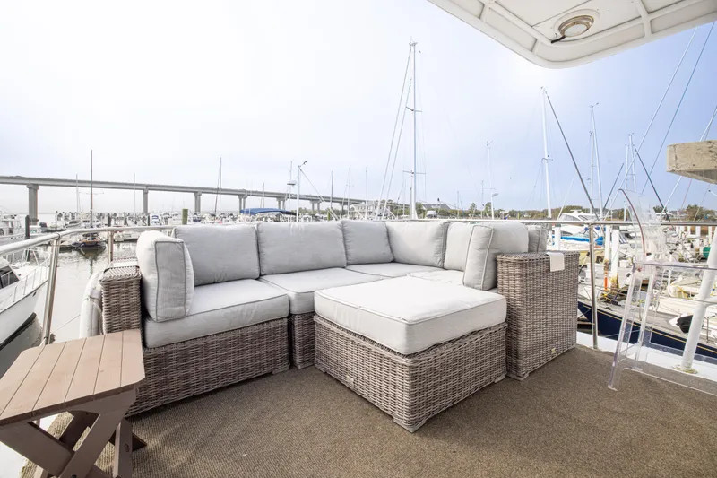 Slide: The Image of 1980 Hatteras 53 Motor Yacht deck with wicker seating, marina view. - 29