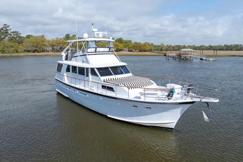 Slide: The Image of 1980 Hatteras 53 Motor Yacht on calm water, showcasing classic design and elegance. - 3