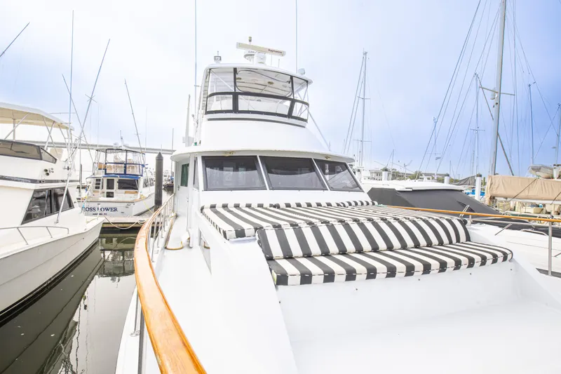 Slide: The Image of 1980 Hatteras 53 Motor Yacht docked with striped sunbed on deck. - 37