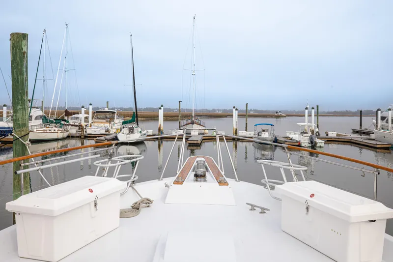 Slide: The Image of Bow view of 1980 Hatteras 53 Motor Yacht docked at marina. - 43