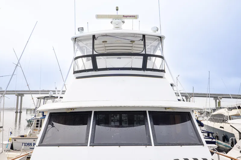 Slide: The Image of 1980 Hatteras 53 Motor Yacht docked at marina, front view. - 47