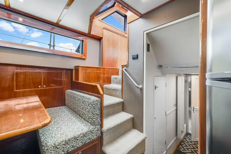 Slide: The Image of Interior of 1980 Hatteras 53 Motor Yacht with stairs and seating area. - 51