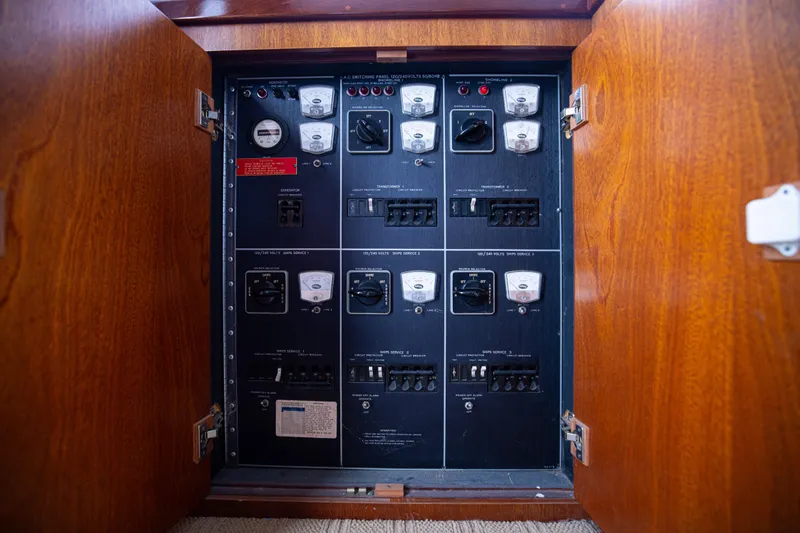 Slide: The Image of Electrical panel inside a 1980 Hatteras 53 Motor Yacht, showcasing switches and meters. - 54