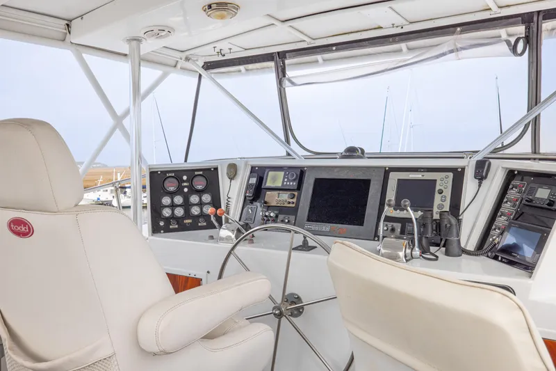 Slide: The Image of Interior helm of 1980 Hatteras 53 Motor Yacht with navigation equipment and captain's chair. - 55