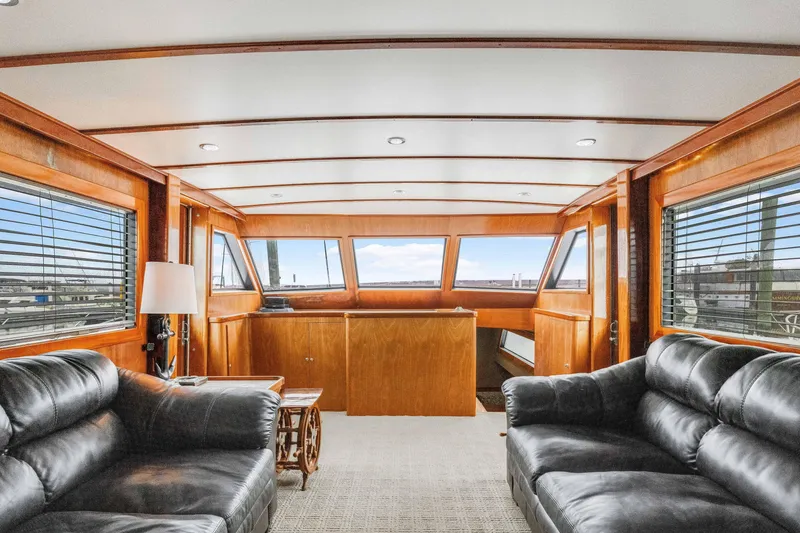 Slide: The Image of Interior of 1980 Hatteras 53 Motor Yacht with leather sofas and wooden paneling. - 62