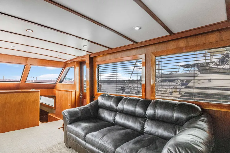 Slide: The Image of Interior of 1980 Hatteras 53 Motor Yacht with leather sofa and wooden paneling. - 64