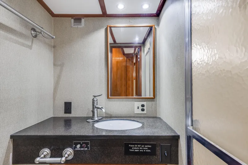 Slide: The Image of Bathroom vanity on 1980 Hatteras 53 Motor Yacht with mirror and modern faucet. - 73
