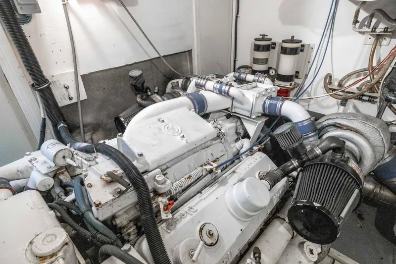 Slide: The Image of Engine room of a 1980 Hatteras 53 Motor Yacht, showcasing mechanical components and filters. - 79