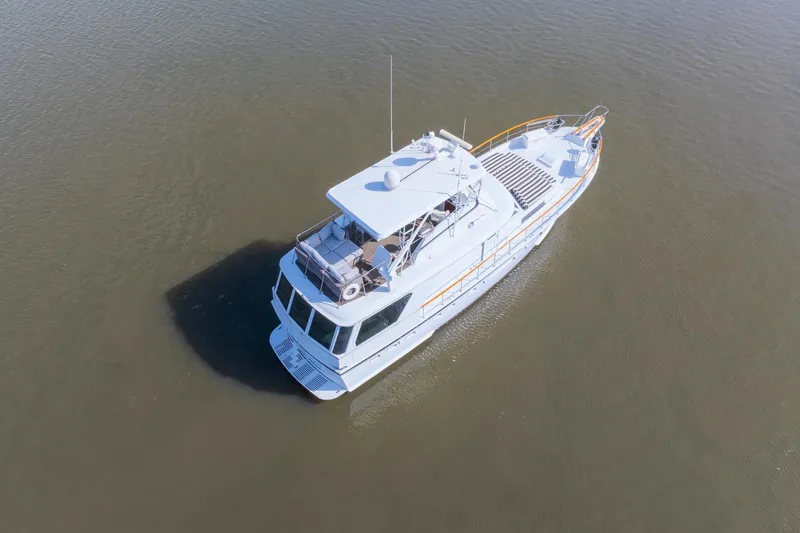 Slide: The Image of 1980 Hatteras 53 Motor Yacht on calm water, aerial view. - 8