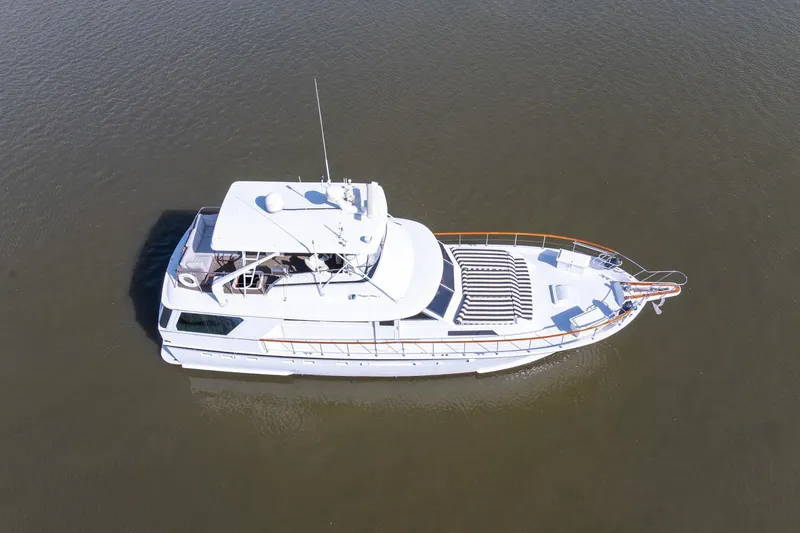 Slide: The Image of 1980 Hatteras 53 Motor Yacht on calm water, aerial view. - 9