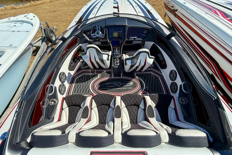 Slide: The Image of Luxurious 2018 MTI 340X boat interior with sleek seating and advanced dashboard controls. - 14