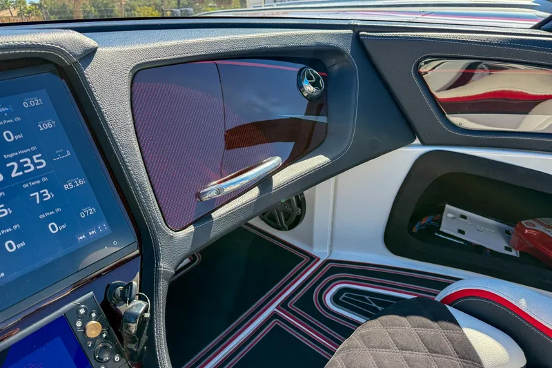 Slide: The Image of Interior of a 2018 MTI 340X boat featuring a digital dashboard and sleek design. - 18