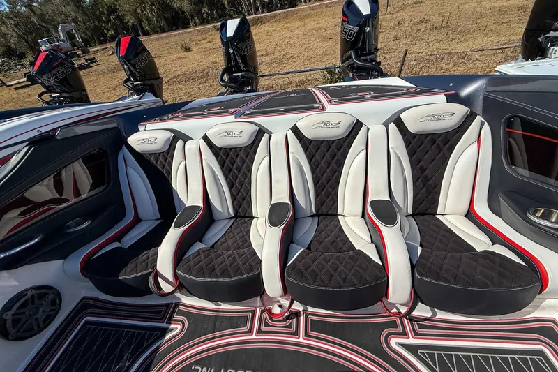 Slide: The Image of Luxurious seating in a 2018 MTI 340X boat with quad engines, featuring black and white upholstery. - 19