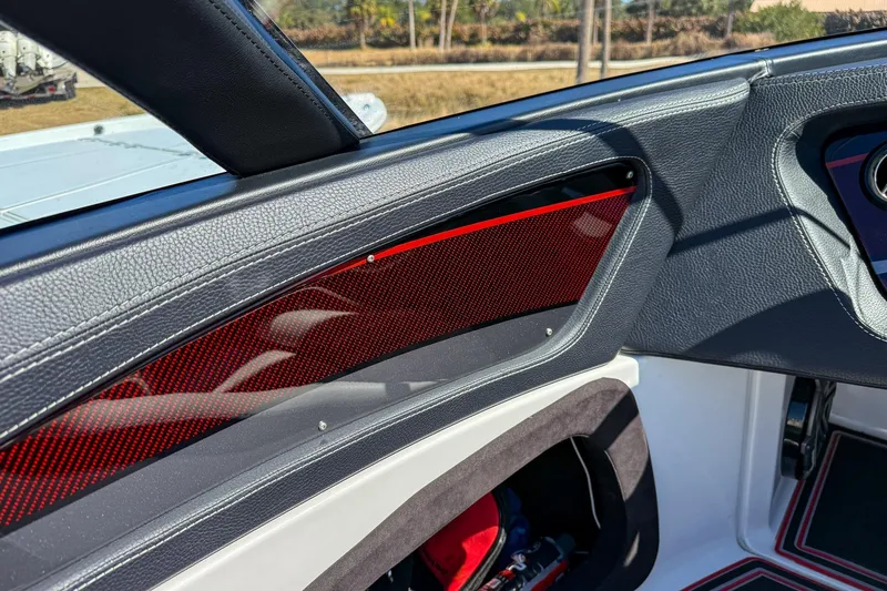 Slide: The Image of Interior of a 2018 MTI 340X boat with sleek black and red accents. - 23