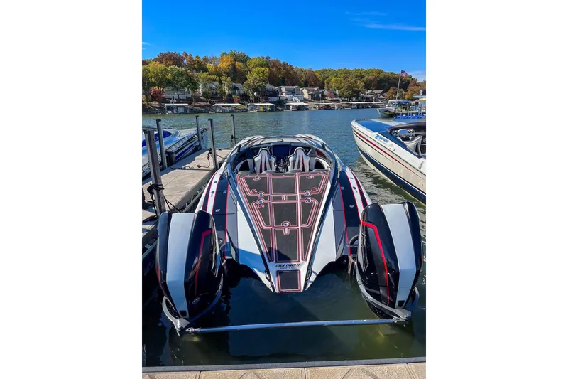 Slide: The Image of 2018 MTI 340X powerboat docked on a sunny lake with scenic background. - 31