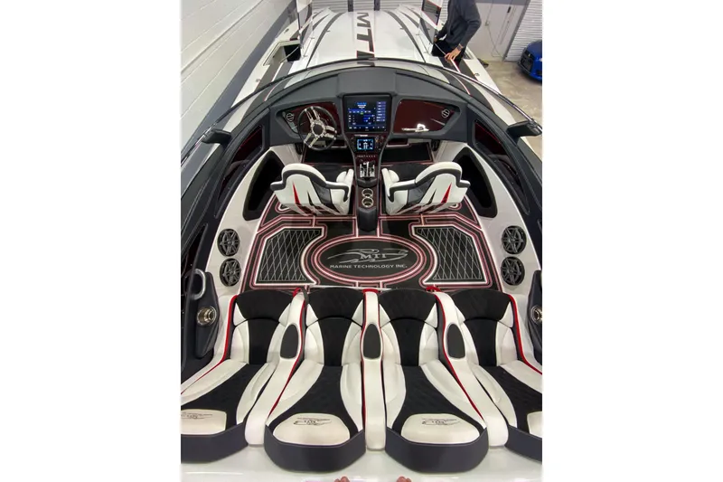 Slide: The Image of Interior of a 2018 MTI 340X boat with sleek seating and modern dashboard. - 32