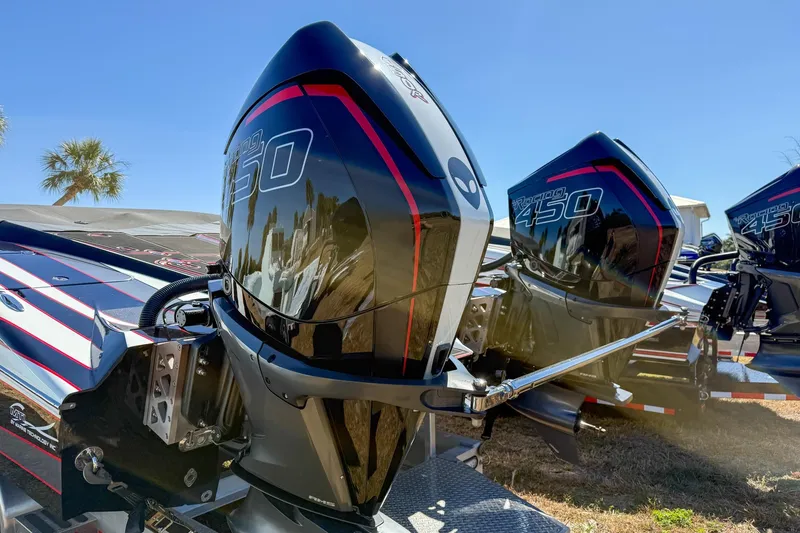 Slide: The Image of MTI 340X 2018 boat with powerful Racing 450 engines, parked outdoors under clear blue sky. - 5