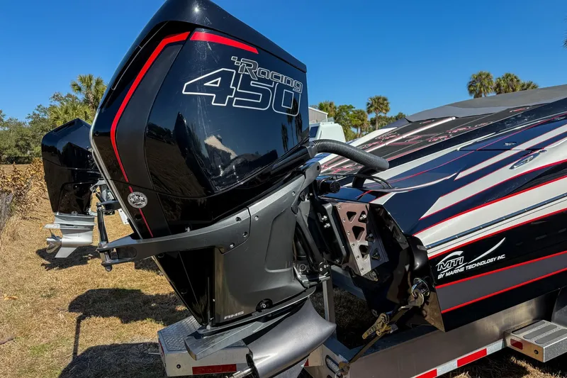 Slide: The Image of Powerful 2018 MTI 340X boat with Racing 450 engine, sleek design, and vibrant graphics. - 6
