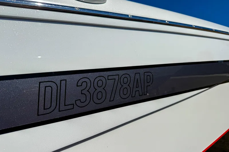 Slide: The Image of Close-up of 2018 MTI 340X boat registration number DL3878AP on sleek white hull. - 7
