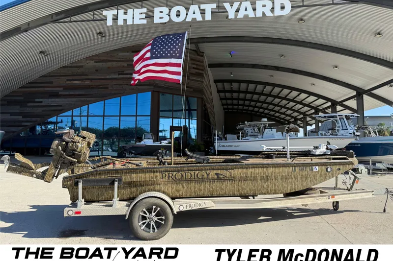 The Image of Prodigy 1854 boat, 2022 model, on trailer at The Boat Yard with American flag. - 0