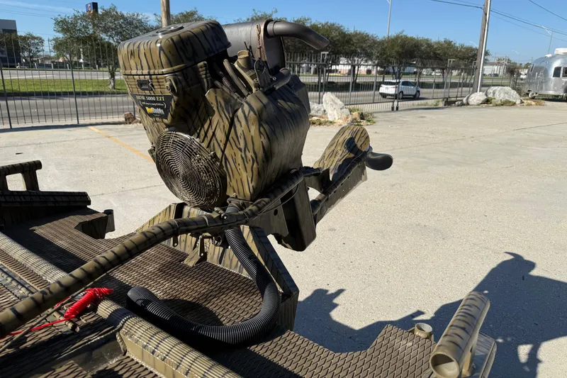 Slide: The Image of Camouflage-patterned Prodigy 1854 boat motor, 2022 model, in an outdoor setting. - 9
